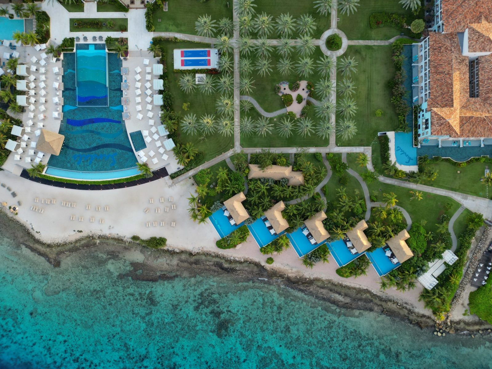 Aerial view of the infinity pools and waterfront at Sandals Curacao, formerly Sandals Royal Curacao