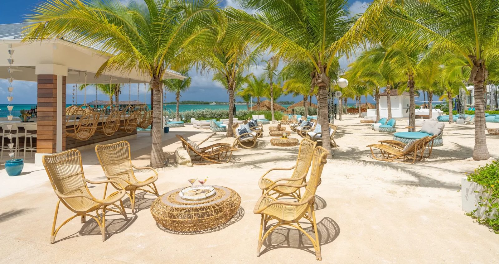 Beach loungers and palm trees at Sandals Bahamas Nassau, the resort formerly named Sandals Royal Bahamian